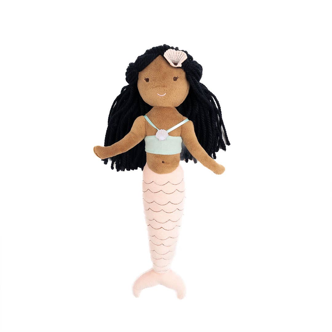 A mermaid plush doll with long black yarn hair, a seashell headpiece, a pale mint top, and a pink scalloped tail, shown against a plain white background.