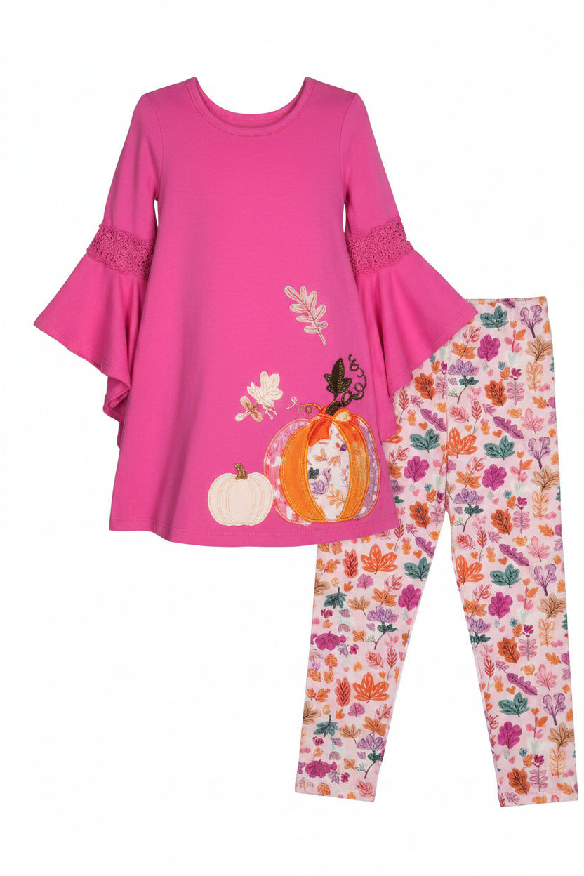 Pink top and patterned leggings set on a plain background
