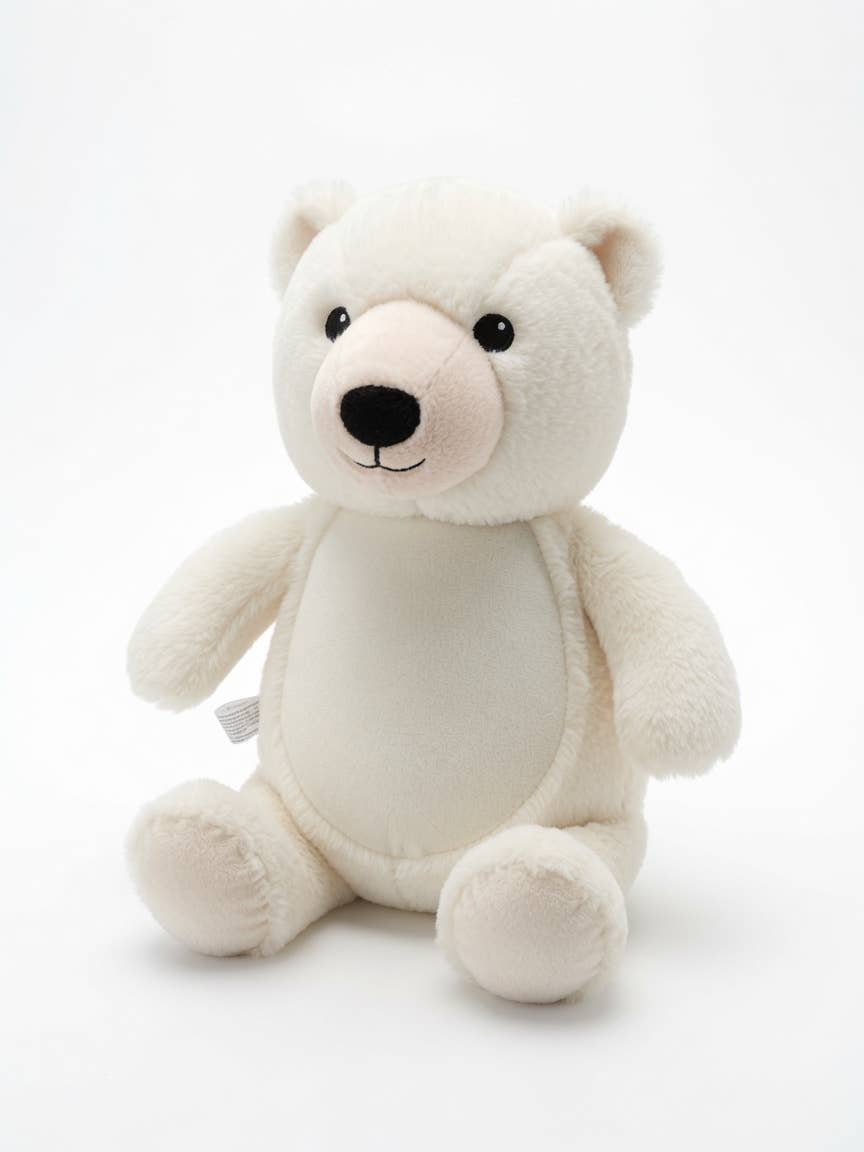 A small plush polar bear toy sitting upright against a seamless white background. The bear is cream-colored with a soft pink snout and black embroidered eyes and nose.