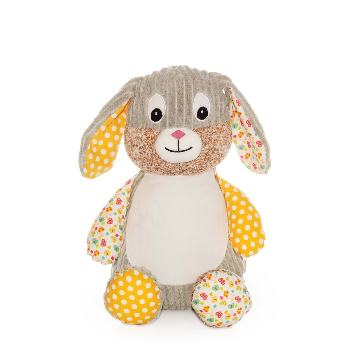 Colorful stuffed bunny made of different materials sits in front of a white background