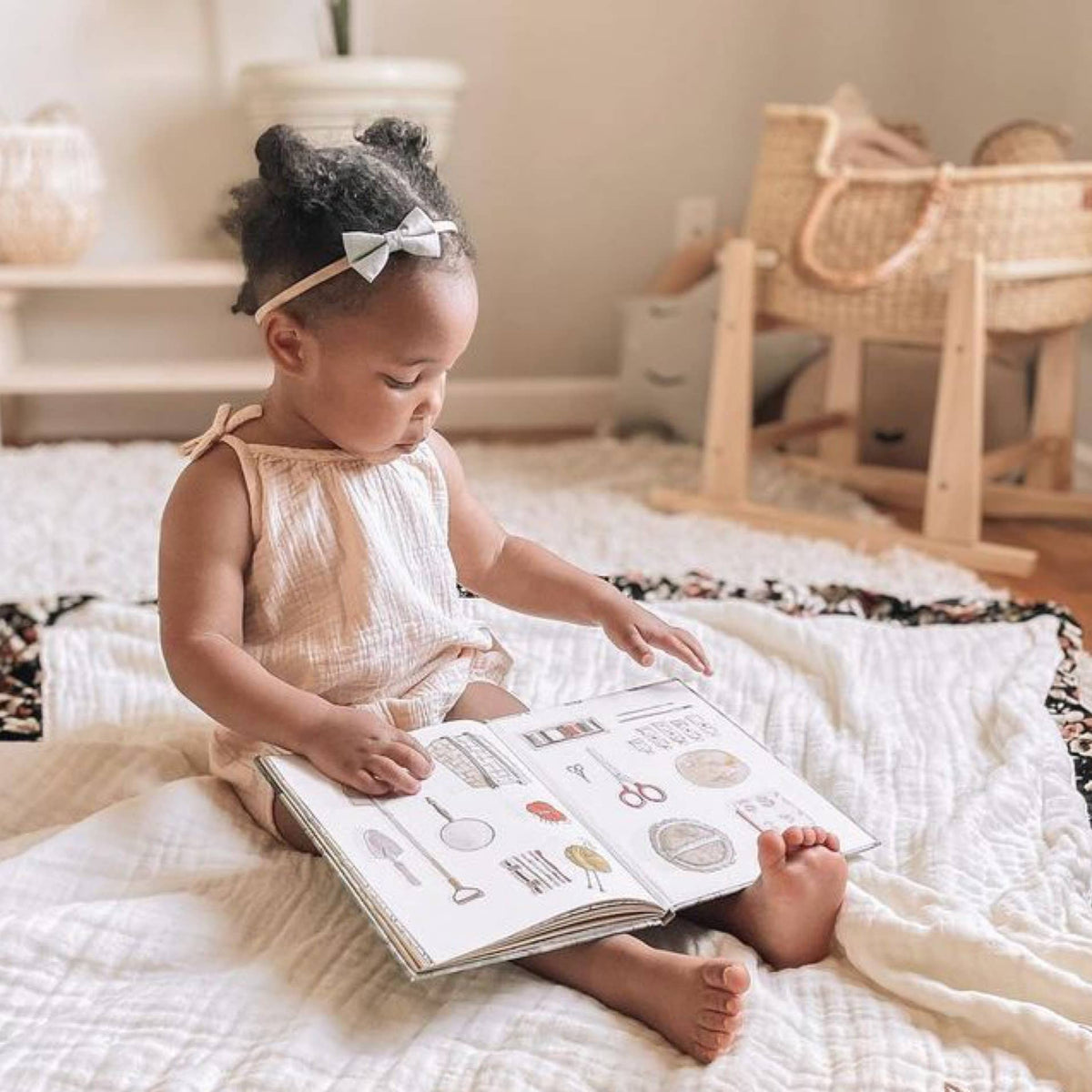 Child reading a book on a bed in a cozy room
