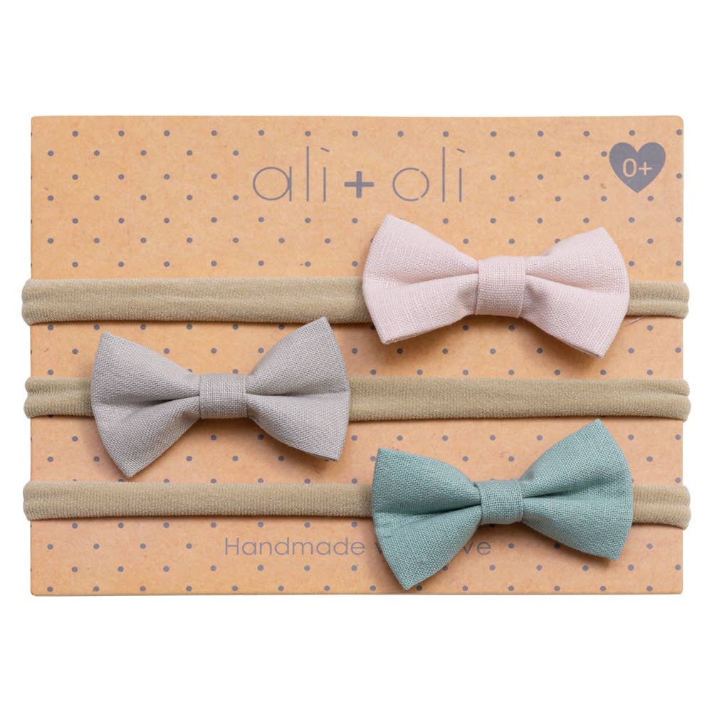 Set of three fabric hair bows on a polka dot box with 'ali+oli' branding.