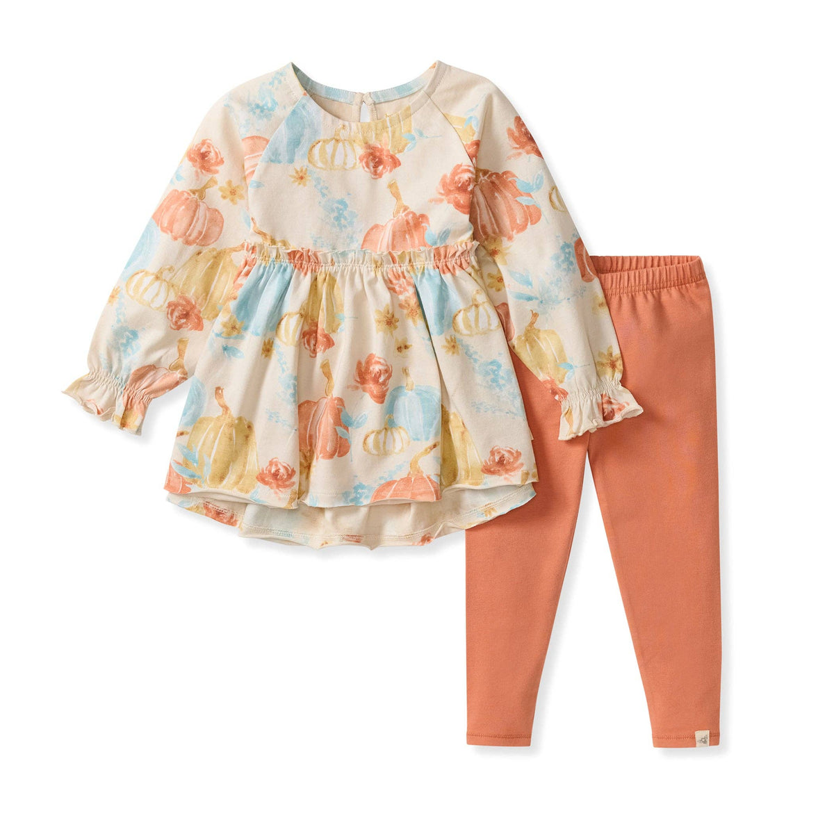 Children's outfit with floral top and pink pants on a white background