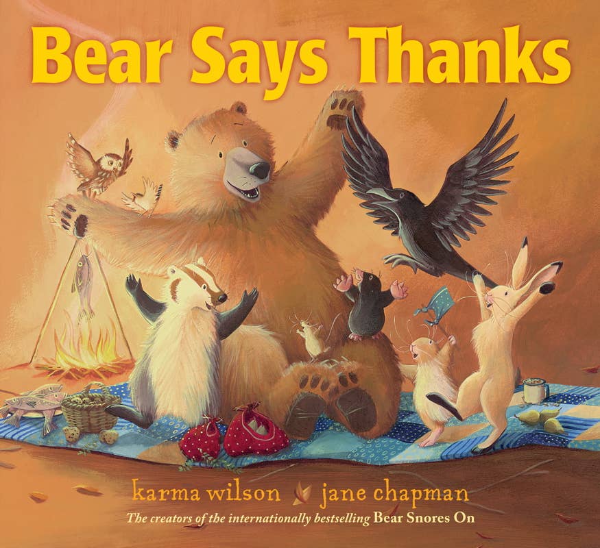 Image of a picture book with title 'Bear Says Thanks' and forest animals celebrating a feast. 