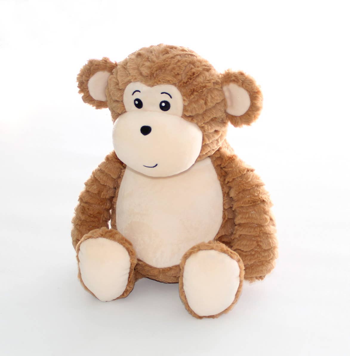 Plush brown monkey with tan stomach and ears sits against a white background. 