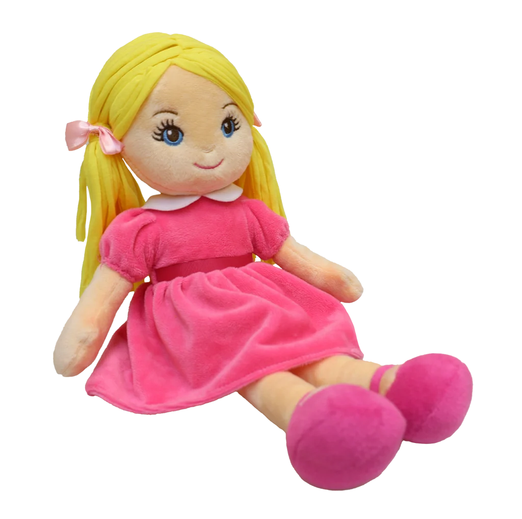 Doll with blonde pigtails and blue eyes wearing a pink dress, pink shoes, and pink matching bows, sits against a white background. 