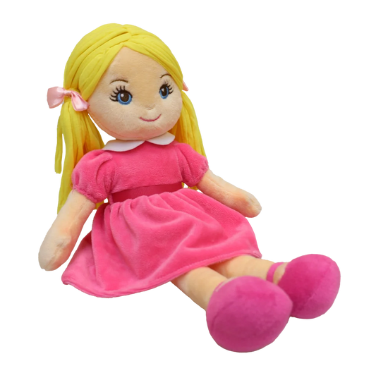 Doll with blonde pigtails and blue eyes wearing a pink dress, pink shoes, and pink matching bows, sits against a white background. 