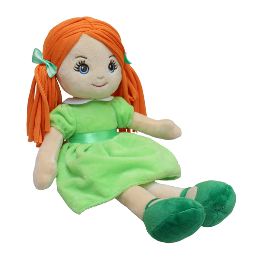 A pale doll with red pigtails and green eyes wearing  a green dress, green shoes, and has green bows to match sits against a white background. 