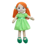 A pale doll with red pigtails and green eyes, dressed in a green dress with matching green shoes and bows, sits against a white background.
