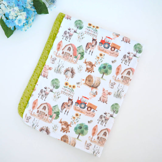 Blanket folded on a white background with a farm theme