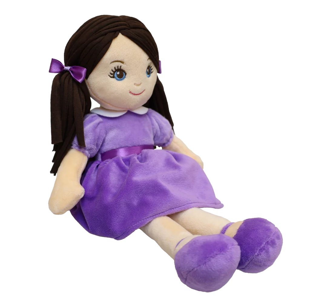Pale doll with black hair and blue eyes wearing a purple dress, purple shoes, and a purple bow against a white background. 