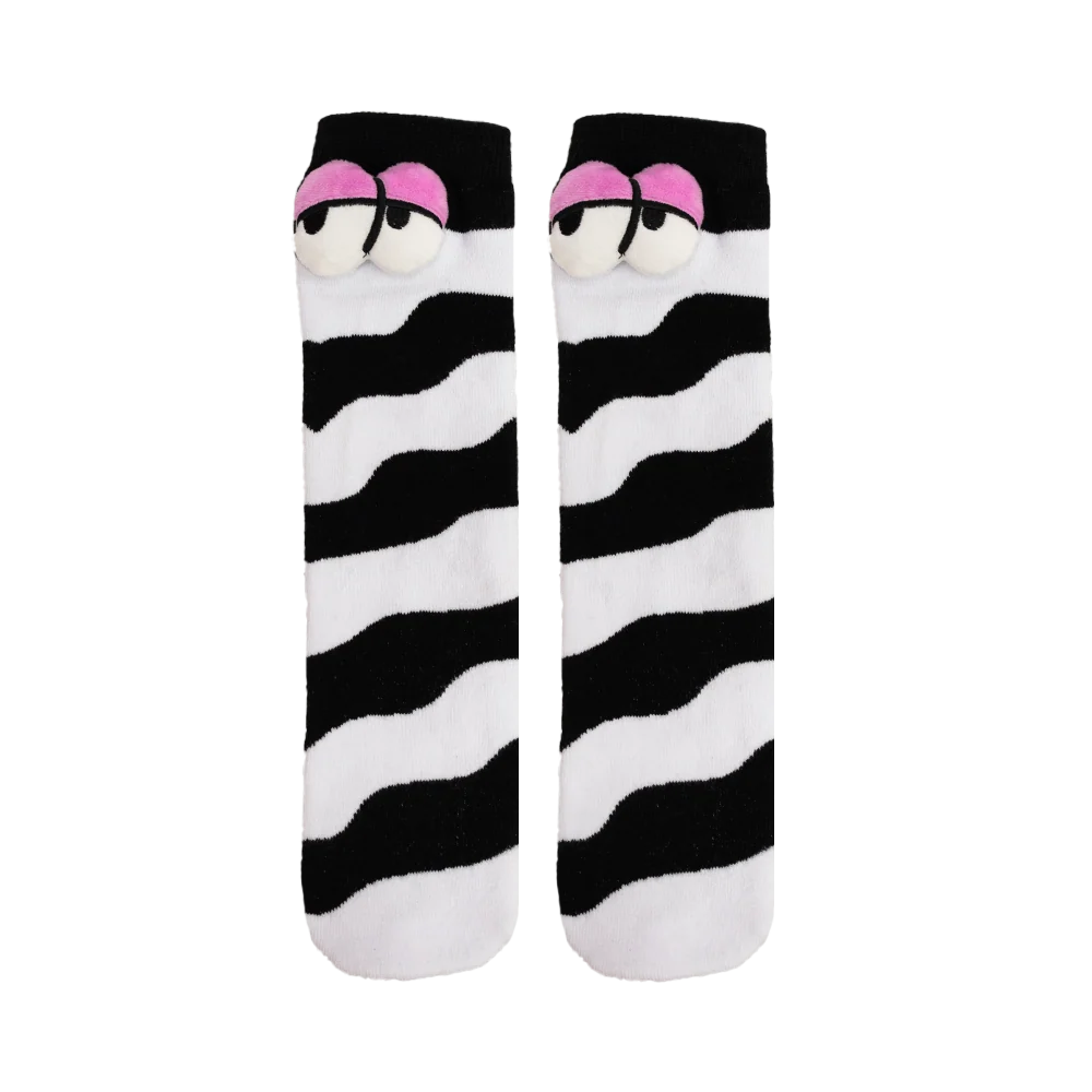 Pair of black and white socks with plush eyes on each, against a white background. 