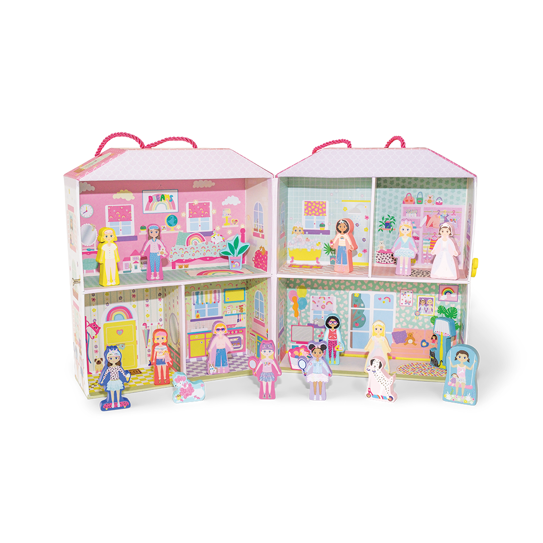 Inside view of a playhouse with different rooms and wooden figures positioned in front of the house. 