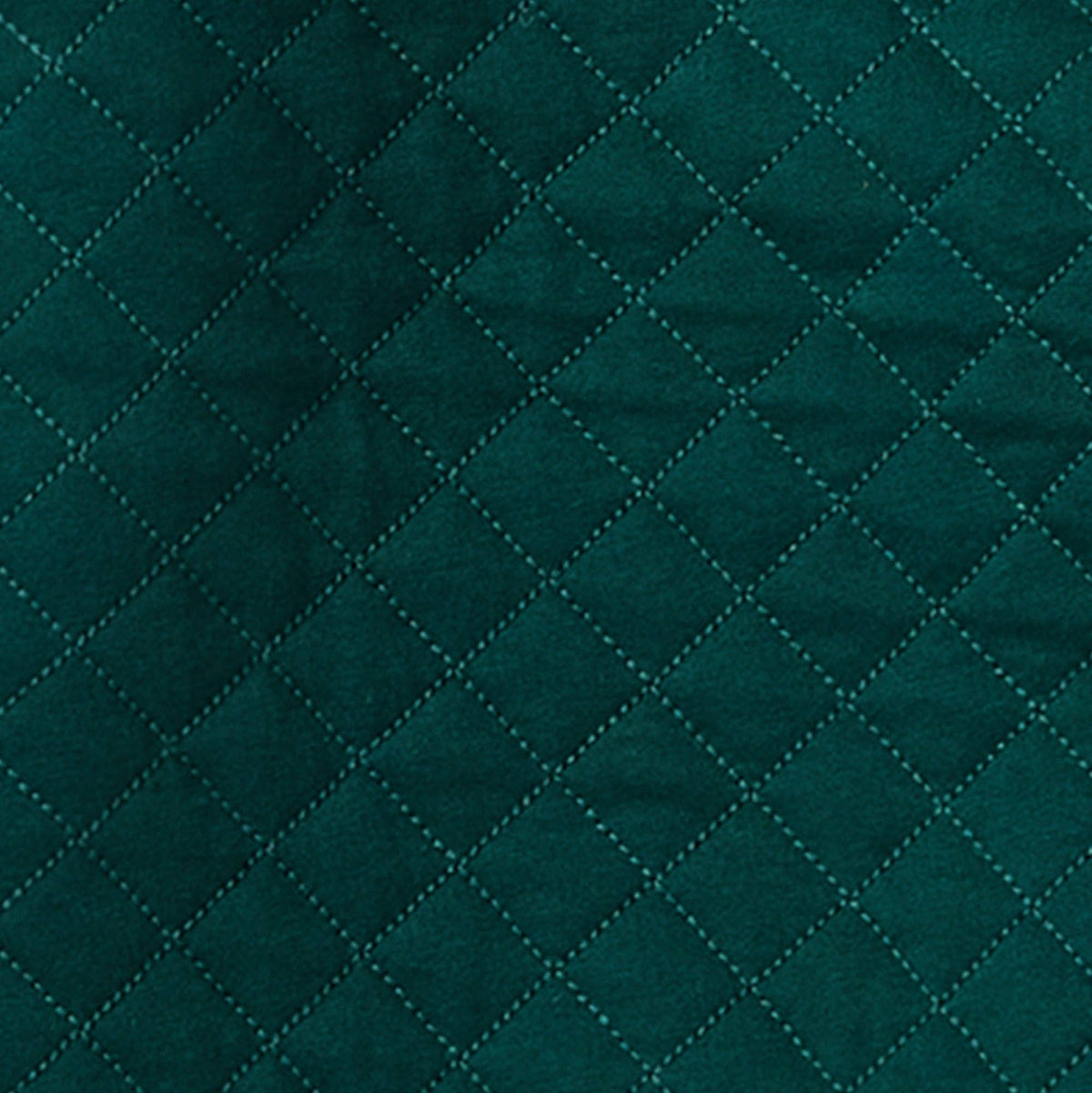 Close up of green quilted fabric. 