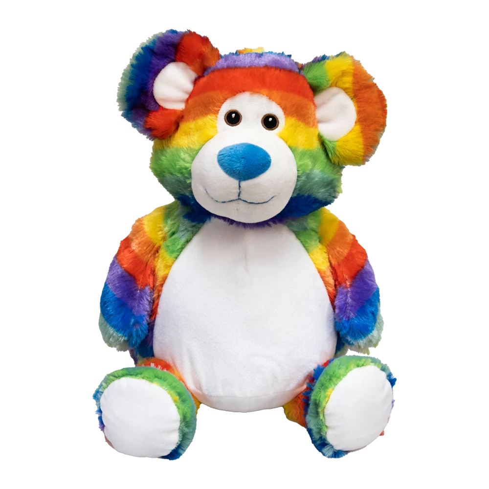 A plush rainbow striped bear with white ears & belly sits against a white background. 