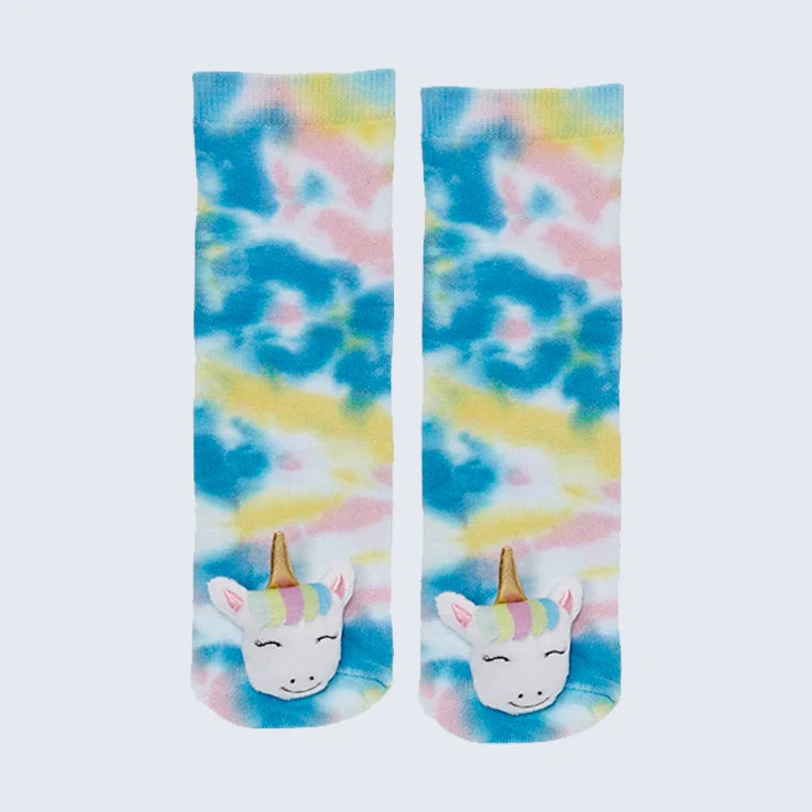 Tie dye socks with blue, pink, and yellow with a unicorn plush head on the toes against a white background. 
