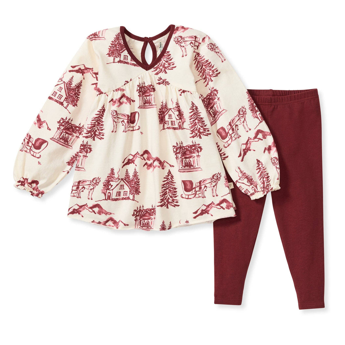 A vintage inspired Christmas tunic with a classic christmas motif pattern and accompanying wine pants against a white background. 