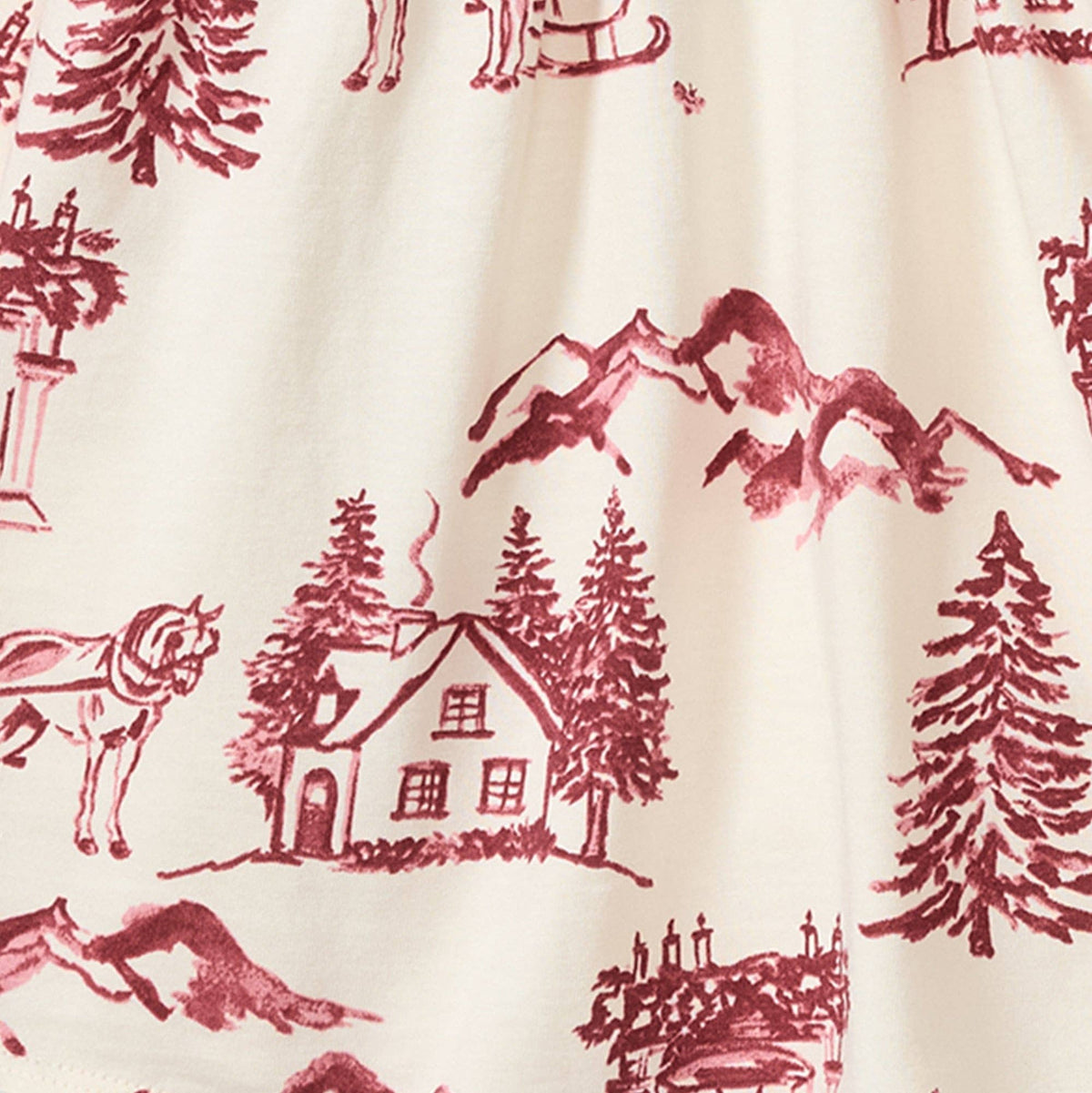 Close up of cream colored fabric with wine colored illustrations of mountains, a chalet, pine trees, a hearth, and horse drawn sleighs. 