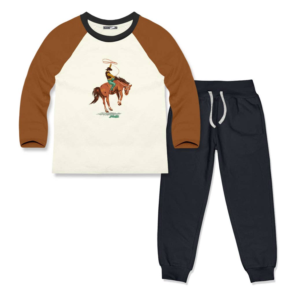 Outfit with a western themed graphic on a cream shirt with tan arms. Matching pants acompany on a white background. 