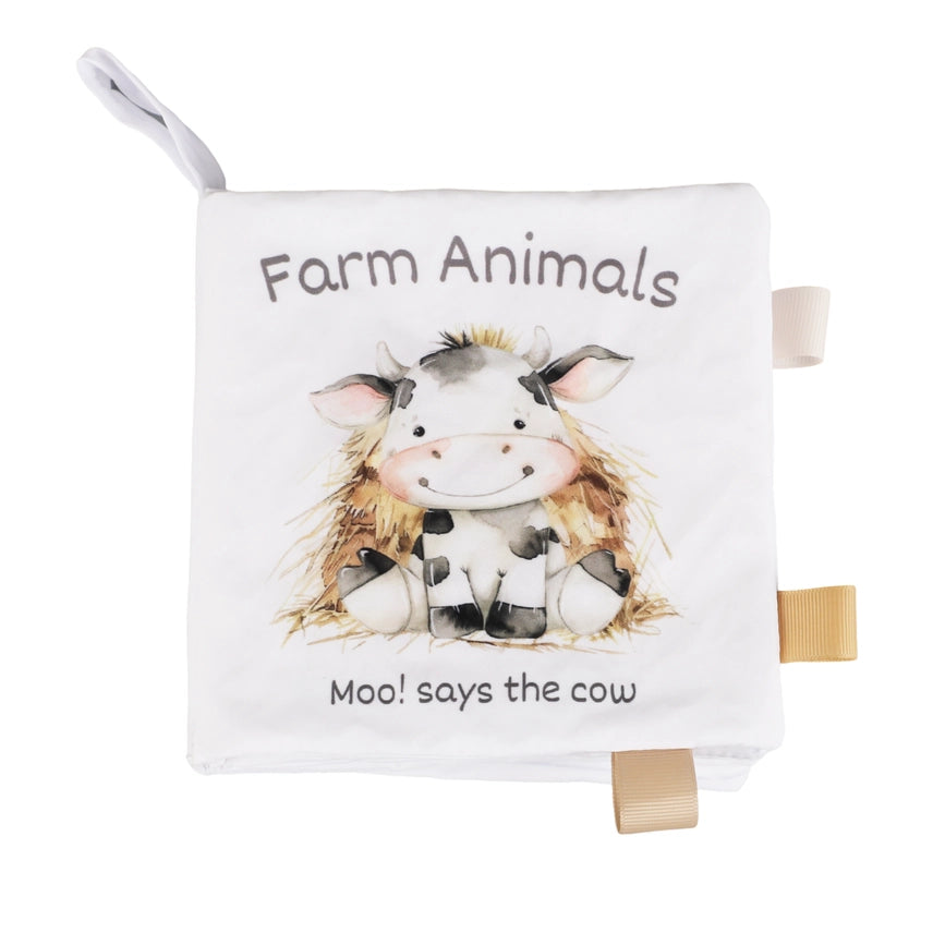 Children's soft book titled 'Farm Animals' with a cow illustration on a white background