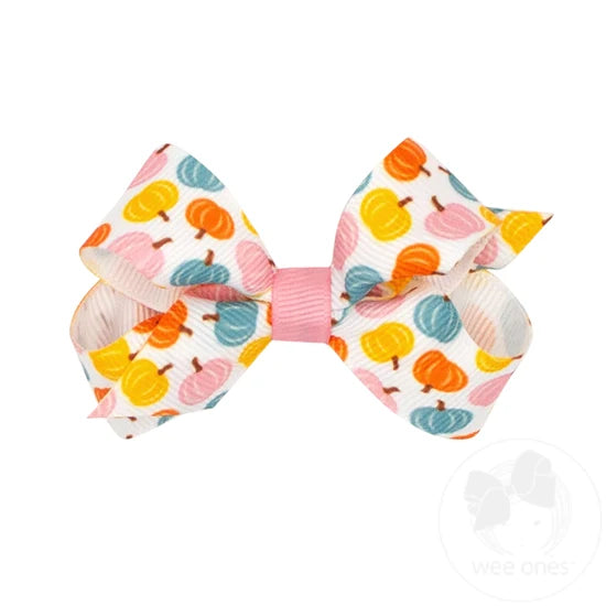 Mini white bow with colorful harvest pumpkins. 