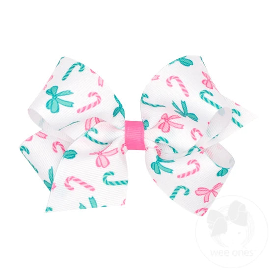 White bow with green and pink candy cane print and hot pink center ribbon. 