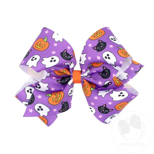 Purple bow with ghosts, black cats, and pumpkins. 